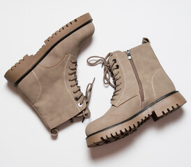 Gray women's winter boots with laces on a white background. The concept of modern women's fashion