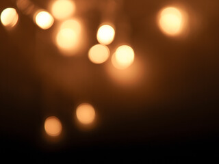 Golden and dark brown round bokeh lights festive background