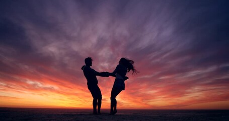 Silhouette, sunset and couple dance on the beach, love and happiness for romance, relax or relationship. Sky, man or woman on seaside vacation together, romantic or celebration for marriage or dating - Powered by Adobe
