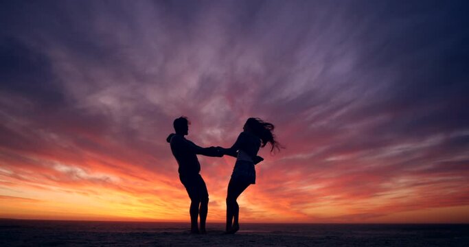Silhouette, sunset and couple dance on the beach, love and happiness for romance, relax or relationship. Sky, man or woman on seaside vacation together, romantic or celebration for marriage or dating