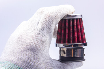 Conical chrome air filter with  - tuning accessory on a gray background