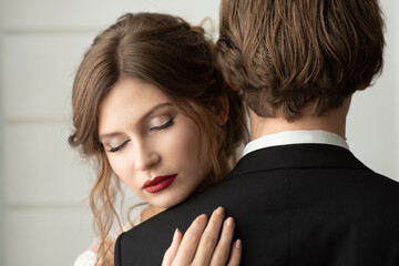 Bride woman in a wedding dress with a beautiful hairstyle, closed her eyes