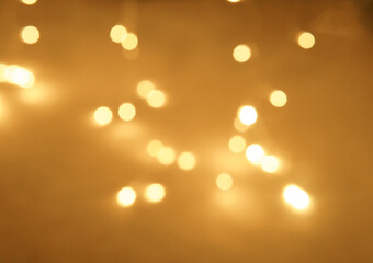 Golden and dark brown round bokeh lights festive background