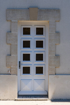 Gray entrance doors with sticket windows in France
