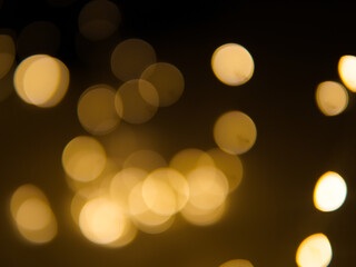 Golden and dark brown round bokeh lights festive background