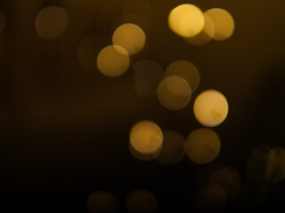 Golden and dark brown round bokeh lights festive background