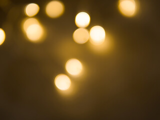 Golden and dark brown round bokeh lights festive background