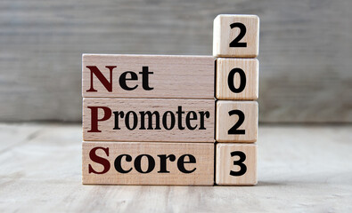 NET PROMOTER SCORE 2023 - words on wooden blocks on gray background
