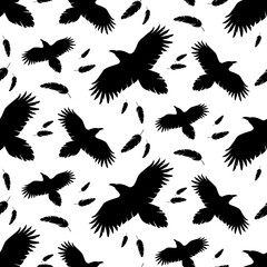 Silhouettes of flying ravens and falling feathers. Black and white seamless pattern. Best for textile, wallpapers, wrapping paper, package and decoration.