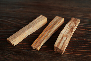 Palo santo sticks on wooden table, closeup