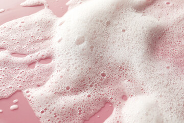 Obraz na płótnie Canvas White washing foam on pale pink background, top view