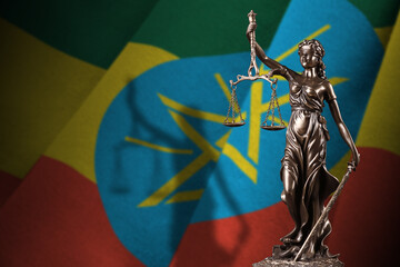 Ethiopia flag with statue of lady justice and judicial scales in dark room. Concept of judgement...