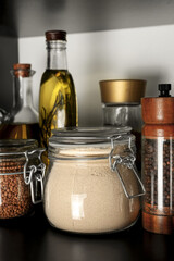 Obraz na płótnie Canvas Glass jar of buckwheat flour on shelf