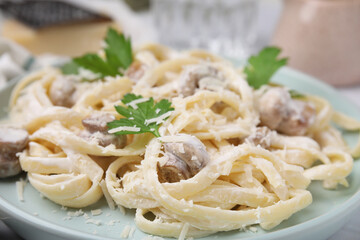 Delicious pasta with mushrooms and cheese on plate, closeup