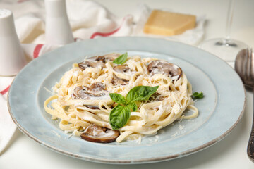 Delicious pasta with mushrooms and cheese on white table, closeup
