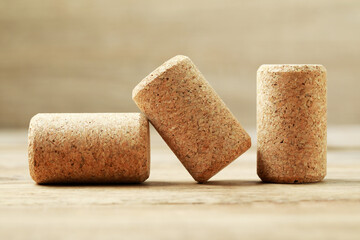 Corks of wine bottles on wooden table, closeup