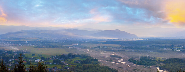 Naklejka na ściany i meble Summer misty morning mountain village panorama (countryside landscape).