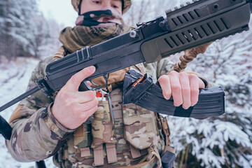 Member of the International Legion loads an AK 47 assault rifle