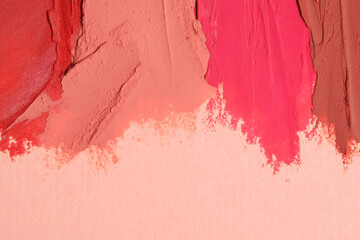 Smears of beautiful lipsticks on beige background, top view. Space for text