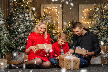 Obraz na płótnie Canvas Family in a Living Room Opening Christmas Presents