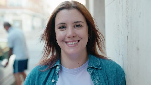 Young beautiful plus size woman smiling confident standing at street