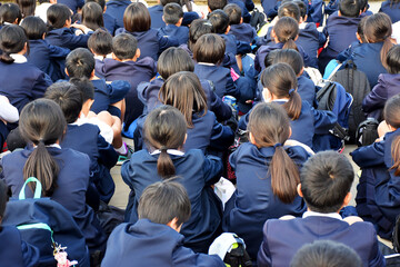 Crowd of Japanese high school students - girls and boys - wearing blue elegant identical school...