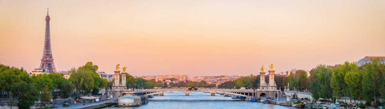 Pont Alexandre III bridge and Eiffel Tower at sunrise in Paris. France