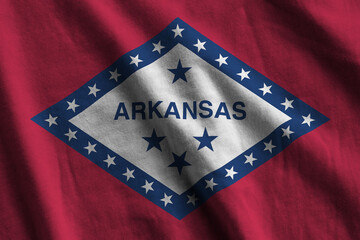 Arkansas US state flag with big folds waving close up under the studio light indoors. The official...