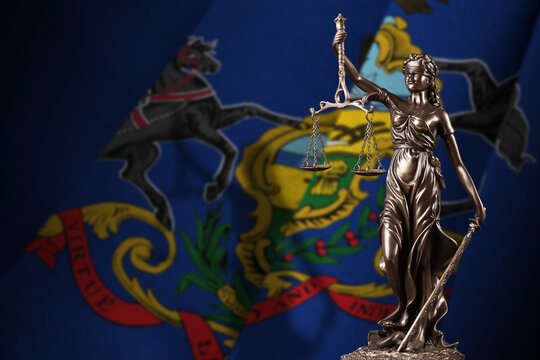 Pennsylvania US state flag with statue of lady justice and judicial scales in dark room. Concept of judgement and punishment, background for jury topics