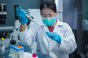 Scientist woman use micropipette with sample preparation from test tube of sample stock solution in...