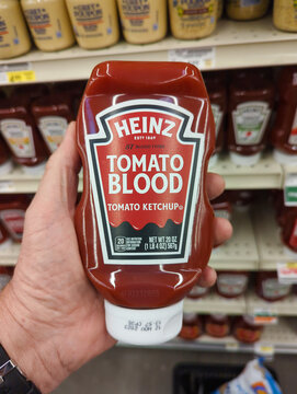 Phoenix, AZ, USA - November 4 2022: Funny bottle of Heinz tomato blood ketchup in man's hand at the grocery store.