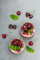 Delicious Italian dessert panna cotta with sweet cherry sauce, fresh berries and mint leaves