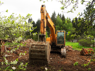 Demolition of a building by an industrial yellow excavator. Demolished broken walls a pile of...