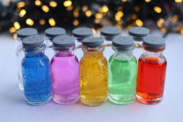 Colored aqueous solutions of acid basic dyes are in glass jars.