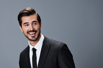 Portrait of a business man with a natural smile with teeth on a gray background in a business suit. Business portrait of a stylish man copy space