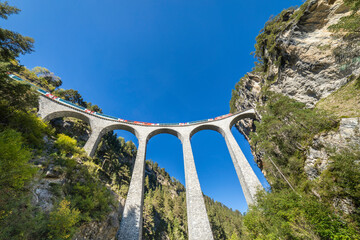 Zwitserse trein over de Landwasser Viaduct-brug in de Alpen, Graubunden, Zwitserland