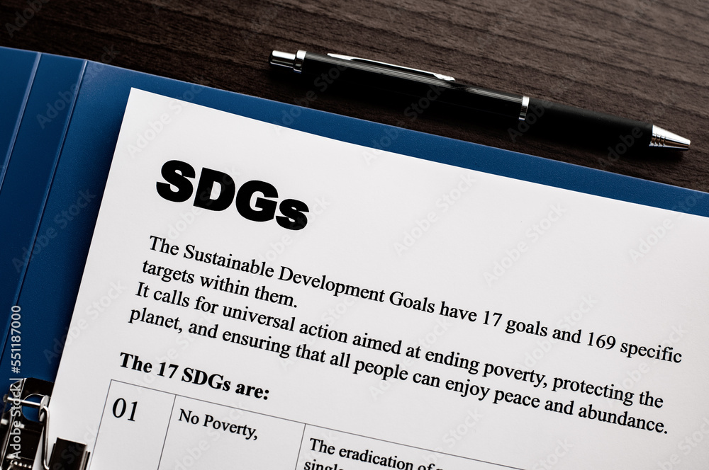 Poster there is dummy documents that created for the photo shoot about sdgs. it's placed on a desk with bin