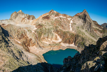 Peaks Gourgs Blancs, Gourdon and Spijeoles over Lac Glacé in summer. Pyrenees. France