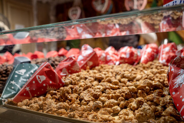 Selective focus at heap of roasted almond on the stall at Christmas market. 