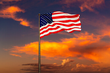 USA flag waving against sunset sky