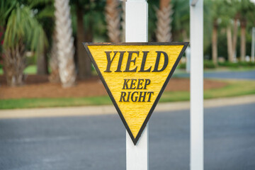 Carved wood road sign with Yield Keep Right at Miami, Florida