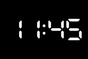 Real white led digital clock on black background