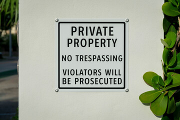 Private Property No Trespassing Violators Will Be Prosecuted on a signage at the wall- Miami, FL
