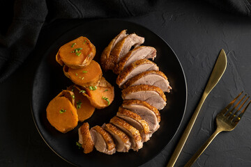 Christmas Roast duck with sweet potato on dark background