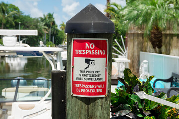 No Trespassing sign on a wood dock post with cap cover at Miami, Florida