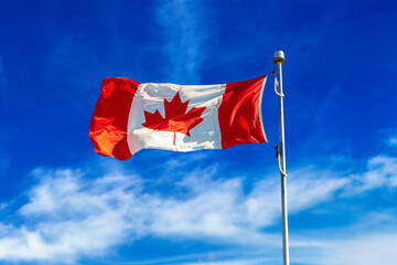 Canadian flag against blue sky
