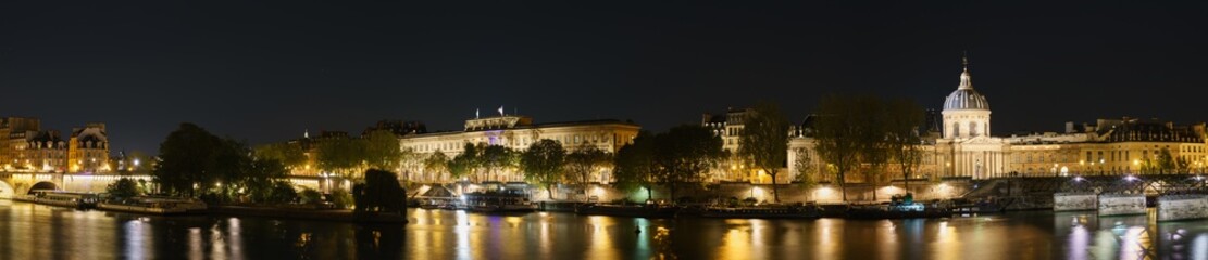 Fototapeta na wymiar Paris evening riverside panorama overlooking Pont des Arts and Pont Neuf bridges