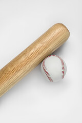 Wooden baseball bat and ball on white background, top view. Sports equipment