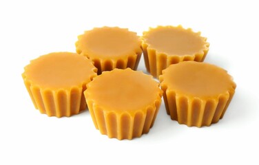 Natural beeswax cake blocks on white background