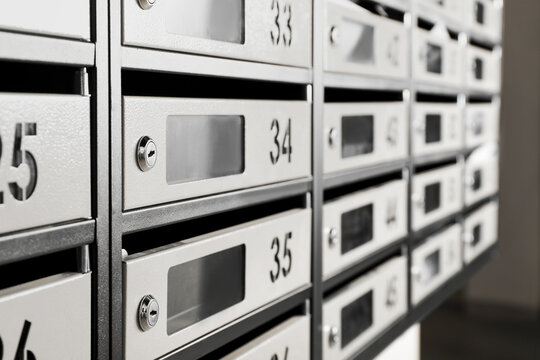 New mailboxes with keyholes, numbers and receipts in post office